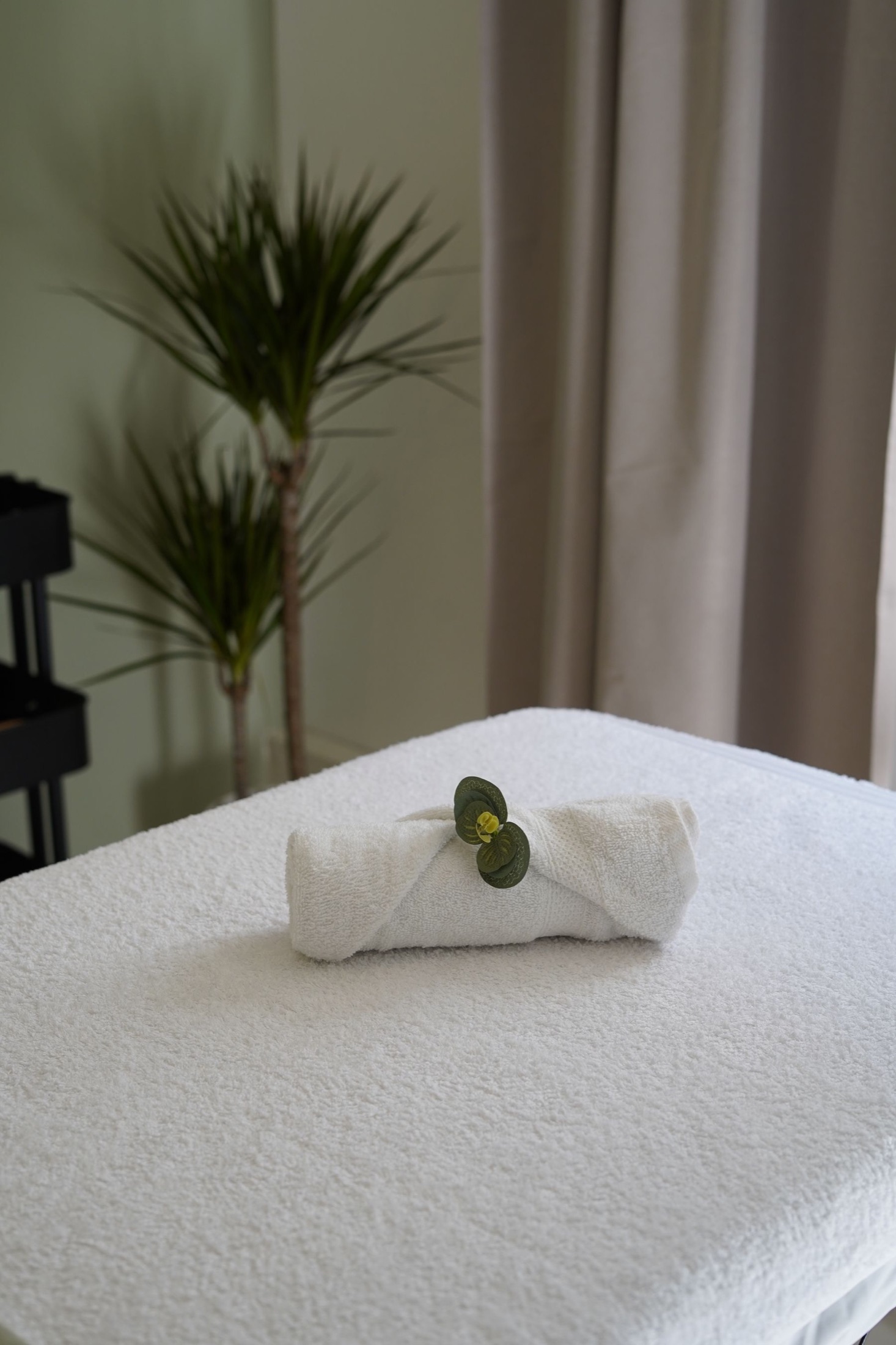 Calm recovery room with fresh towels and greenery